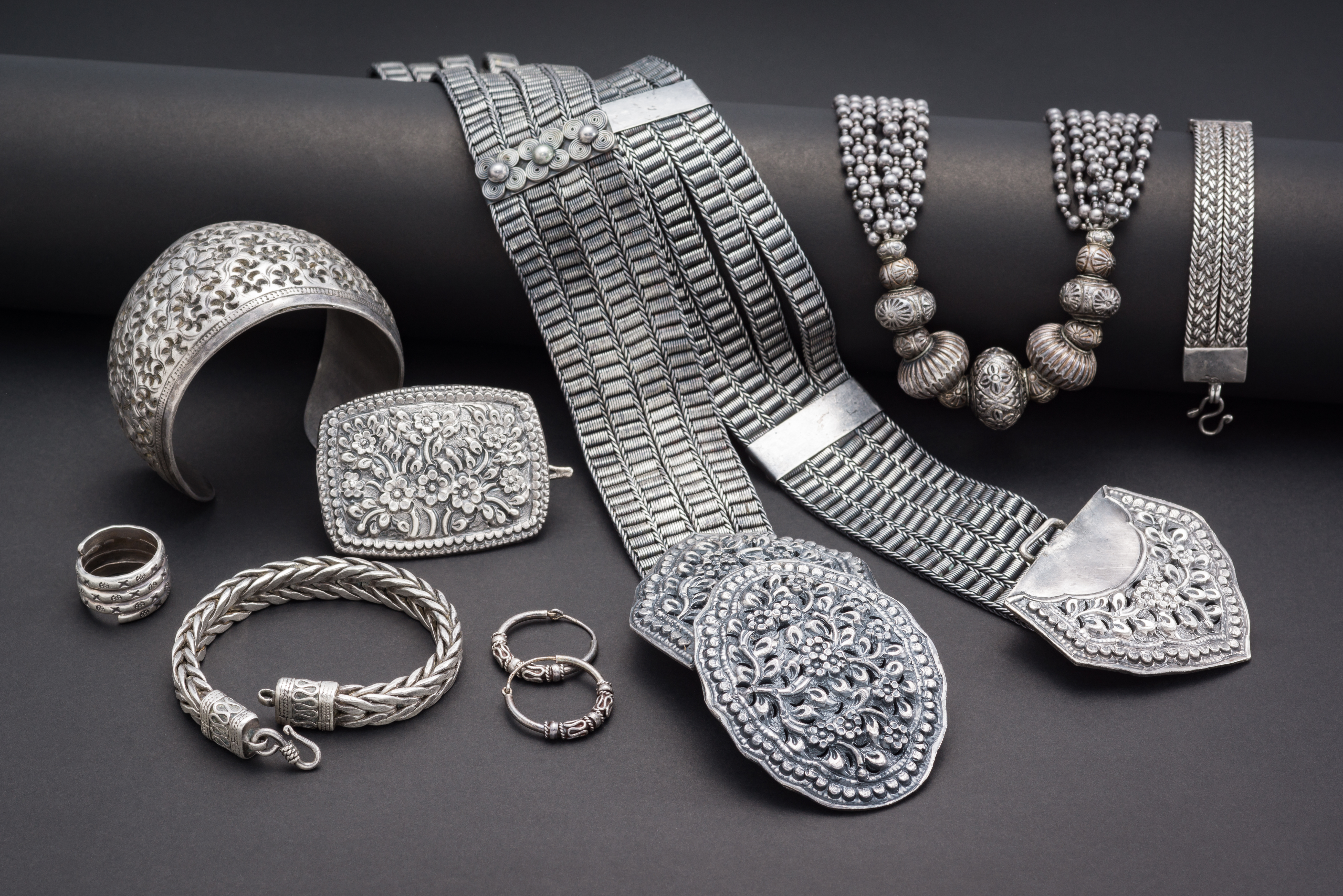 Collection of antique traditional silver jewelry on black paper